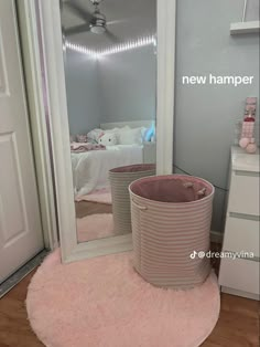 there is a pink rug on the floor in front of a mirror and a basket