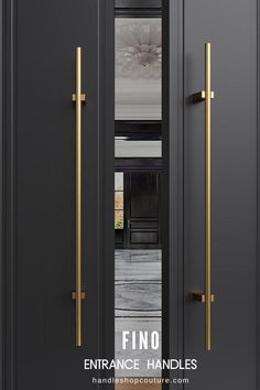 an entrance with two black doors and gold handles