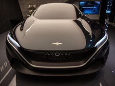 an electric car is on display in a showroom with black and white stripes around the hood