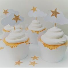 cupcakes with white frosting and gold stars on top