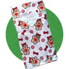 a teddy bear with red bow tie and candy canes on white leggings