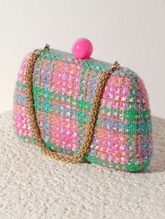 Meet your favorite fall clutch, the Lana Minaudiere from Shiraleah. This versatile bag features a trendy tweed texture in a chic pink and green color pattern with a pink push lock closure. With its interchangeable single handle and cross-body chain, this little purse can be worn as a clutch, a mini bag, or a cross-body! The Lana Minaudiere effortlessly exudes style and sophistication. Pair with other items from the Shiraleah collection to complete your look! Shiraleah is a trend-driven lifestyle Trendy Pink Clutch With Removable Pouch, Pink Formal Bag With Fold Over Clasp, Formal Pink Bag With Fold Over Clasp, Chic Multicolor Clutch With Removable Pouch, Pink Pouch Clutch With Detachable Strap, Pink Clutch With Removable Pouch, Chic Green Clutch With Detachable Handle, Pink Evening Bags With Fold Over Clasp, Trendy Pink Clutch For Events