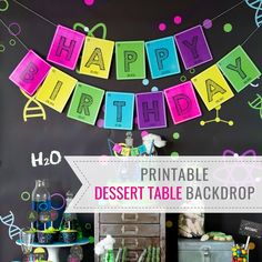 a birthday party with colorful decorations on the wall and an image of a happy birthday banner