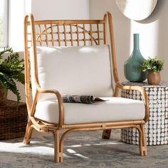 a wicker chair sitting next to a green vase