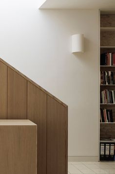 a bookshelf next to a staircase in a room