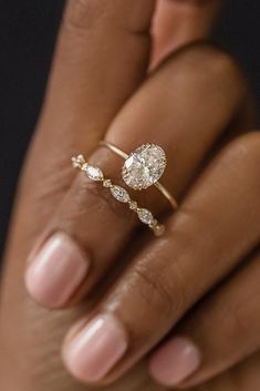 a woman's hand holding a diamond ring with the words melanie casey on it