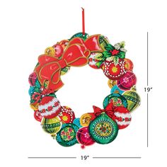 a christmas wreath ornament hanging on a white wall with measurements for the length