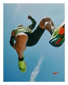 a man flying through the air while riding a kiteboard in front of a blue sky