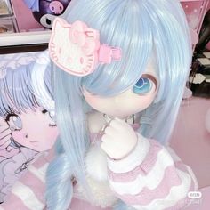 a close up of a doll with blue hair