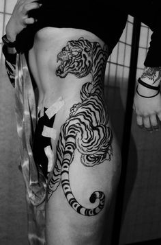 black and white image of a tiger on the side of a woman's body