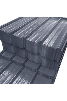 several stacks of metal sheets stacked on top of each other in front of a white background