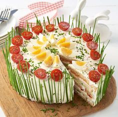 there is a cake that has been decorated with tomatoes and other toppings on it