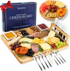 a cheese board with utensils and two trays filled with different types of cheese