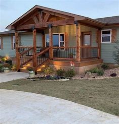 a house with a porch and stairs in the front yard