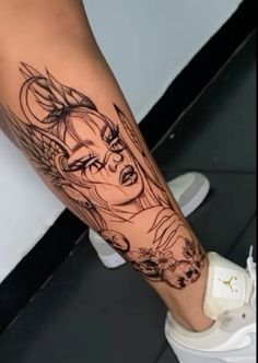 a woman's leg with a black and white tattoo design on her left arm