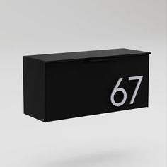 a black mailbox with the number 76 on it's front and side panels