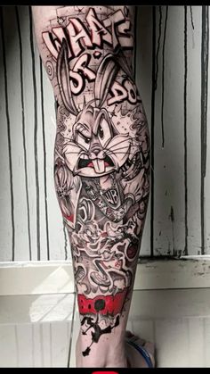 a man's leg with some tattoos on it