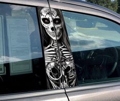 a car with a skeleton sticker on it's side window