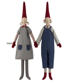 two dolls with red hats and overalls are standing next to each other on white background