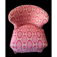 a pink and white patterned chair against a black background, with the seat upholstered