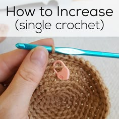 someone is crocheting a small piece of yarn with a toothbrush in it