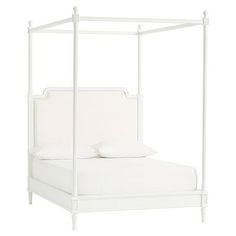 a white bed with four posts and pillows on it's headboard, against a white background