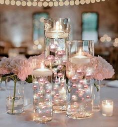 the centerpieces are filled with candles and flowers