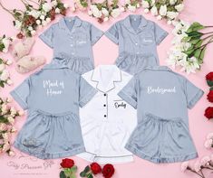 three children's blue and white shirts with names on them next to some flowers