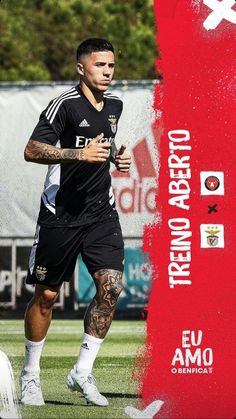 a man with tattoos on his arm playing soccer