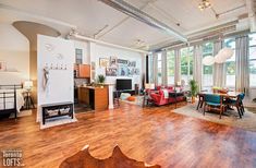 a living room filled with furniture and lots of windows