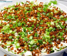 a large white bowl filled with food and toppings