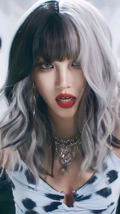 a woman with grey hair and red lipstick