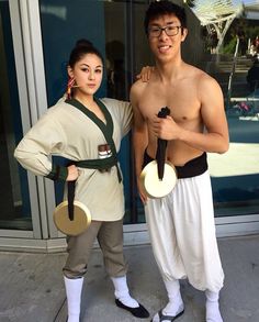 a man and woman in costume standing next to each other