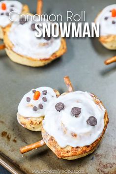 cinnamon roll snowman cookies on a baking sheet