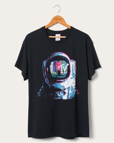 Blast off into retro coolness with our MTV Astronaut Flea Market Tee. Inspired by the golden era of music television, this tee showcases an astronaut floating among colorful stars. Crafted with soft, comfortable fabric, it's a must-have for music and nostalgia lovers. Elevate your style and let your inner space explorer shine! Shop the rest of our Pop Culture Collection HERE. Mtv Astronaut, Tupac T Shirt, Space Explorer, Pop Culture Tshirts, Food Clothes, Music Tees, Movie T Shirts, Mens Graphic Tee, Plus Size T Shirts