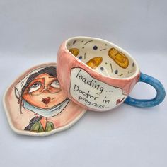 two ceramic mugs sitting on top of each other