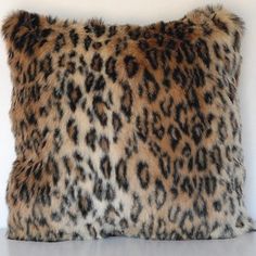 a leopard print pillow sitting on top of a table