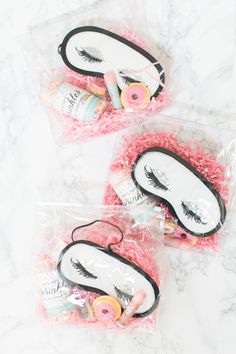 three bags filled with fake eyelashes on top of a marble countertop next to each other