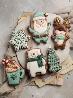 decorated christmas cookies sitting on top of a plate