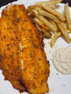 fish and french fries on a white plate