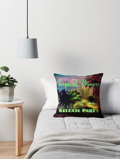 a bed with a pillow that says tropical breeze release party on the front and back