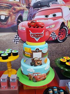 cars birthday cake and cupcakes on display at a children's birthday party