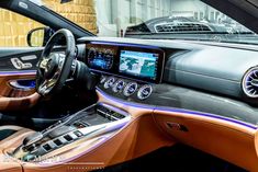 the interior of a car with an electronic display on it's dash board and steering wheel