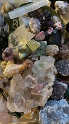 many different colored rocks and crystals on a table