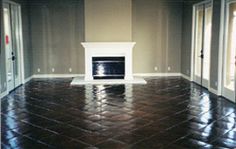 an empty room with a fireplace and doors