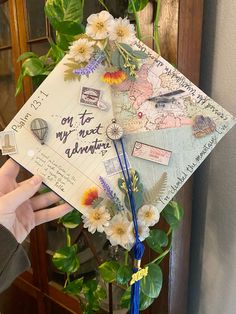 someone is holding up a graduation cap with flowers on it that says, oh to my next adventure