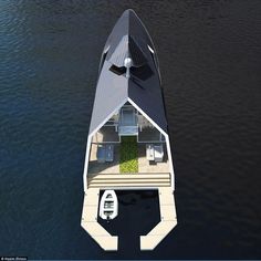 an aerial view of a house boat floating on water