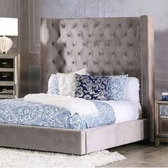 Dramatic flair. This bed shows off a bold, glam look that's just right for your large bedroom. Made from a solid and engineered wood frame, it features a high, eye-catching wingback with low sideboards balanced on block feet. We love that this bed is padded with foam and wrapped in polyester-blend fabric with a neutral hue, so it offers a cushioned surface to lean against in the evenings. Button tufting creates a tailored look, while luminous nailhead trim completes the luxe effect. To complete Gray Upholstered Bed, Making Bed, Transitional Bed, Luxe Bed, Eastern King Bed, Button Tufted Headboard, King Upholstered Bed, Queen Upholstered Bed, Bed King