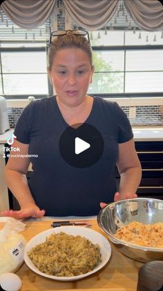 a woman standing in front of a table filled with plates of food and bowls of pasta