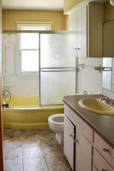 a bathroom with a sink, toilet and bathtub next to a shower stall in the corner